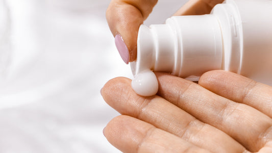 A person pumping cream lotion on left hand