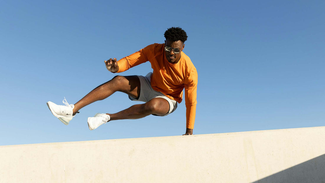 Man jumping over a concrete structure outside