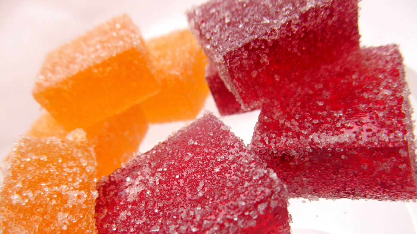Sweet square-shaped gummies in red and orange colors.