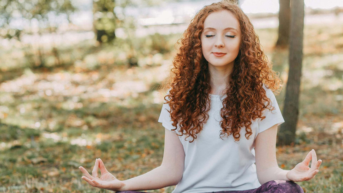 woman meditating in the park