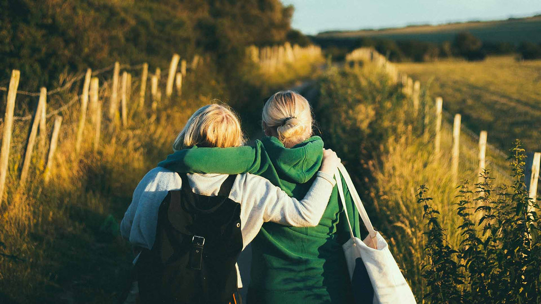 two women walking together outdoor during daytime