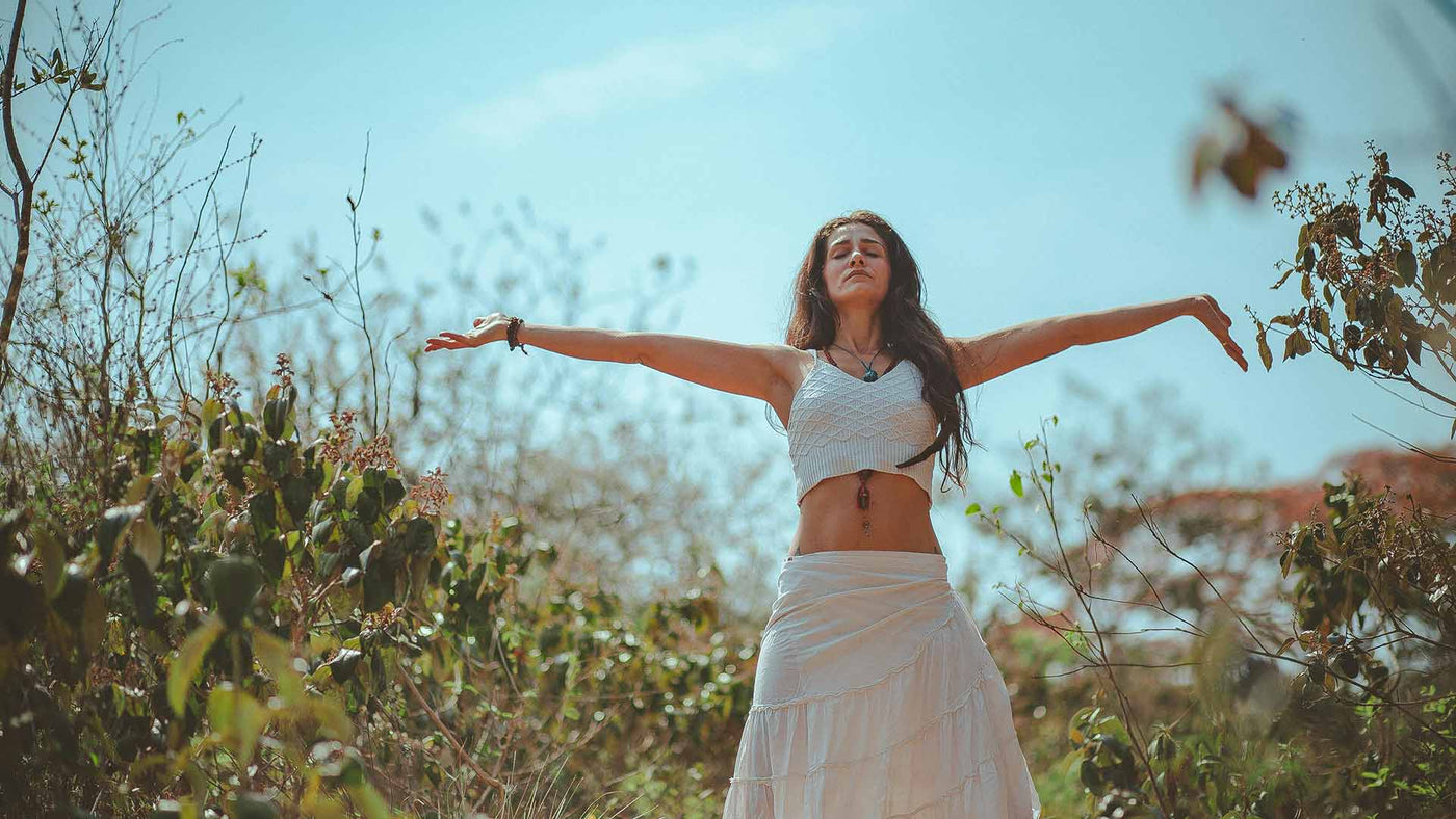 Woman in a field with outstretched arms