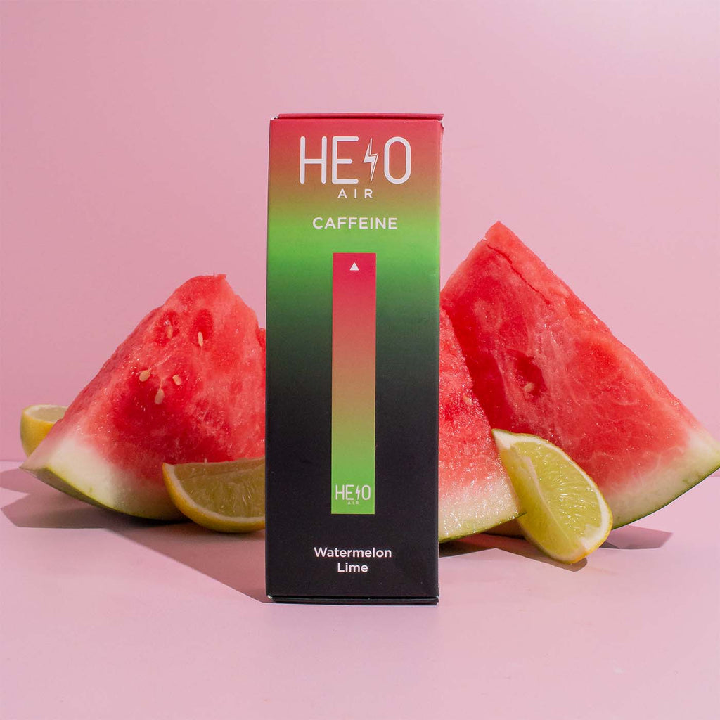 A box of HELO Air caffeine diffuser in Watermelon Lime flavor with slices of watermelon fruit behind it.