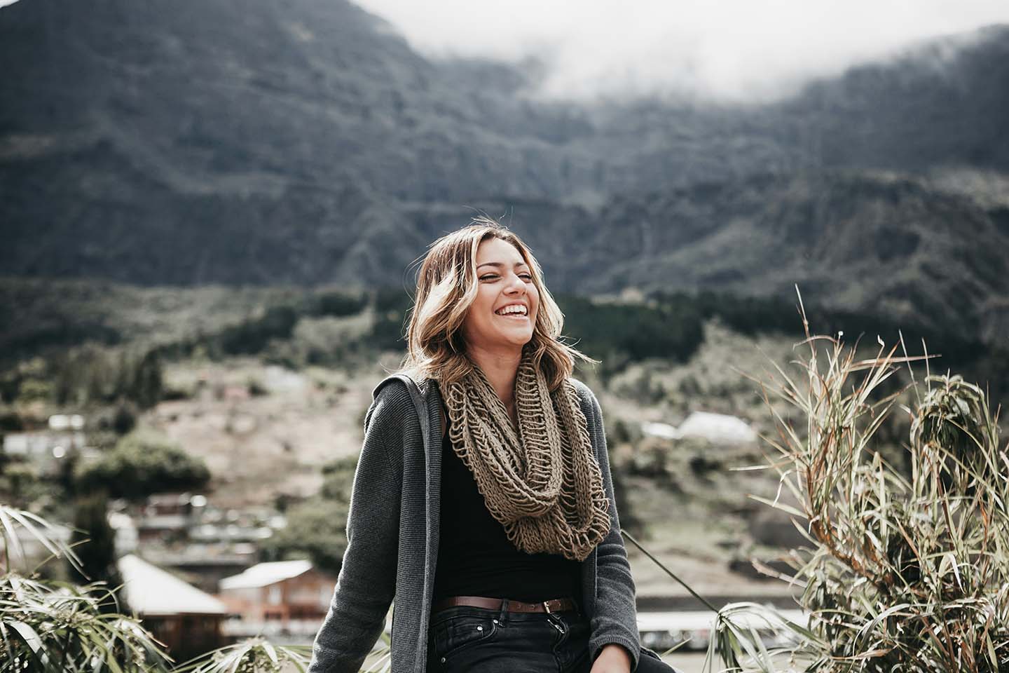 woman sitting outside with mountains in the background