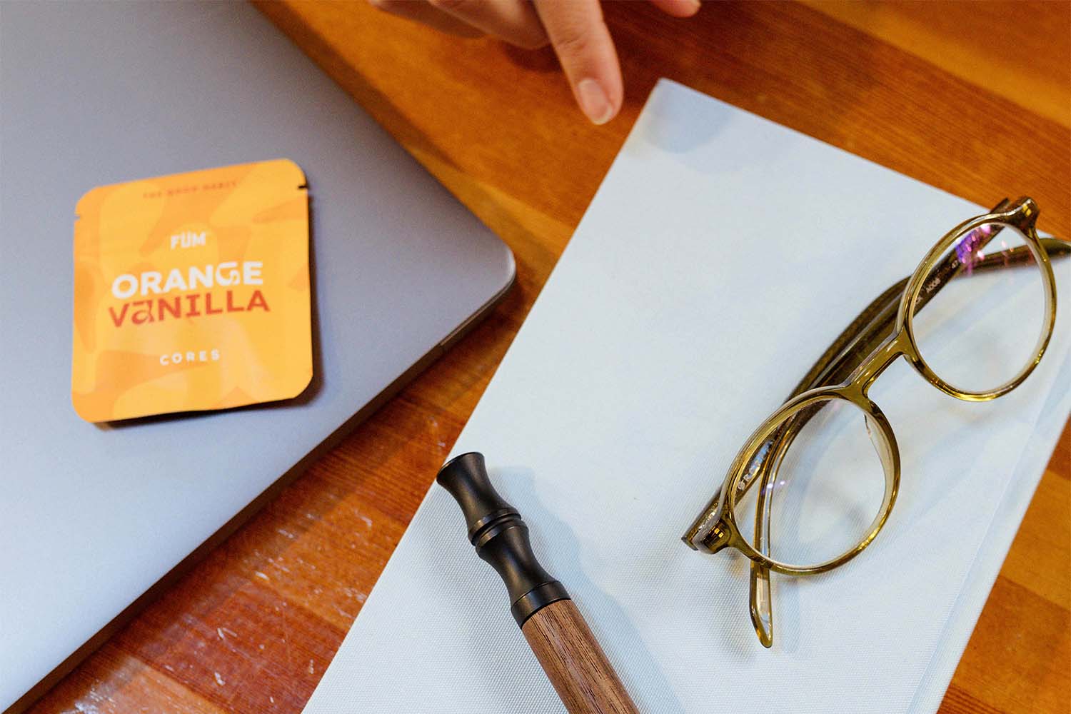 desk with glasses and an FÜM Orange Vanilla Flavor Core