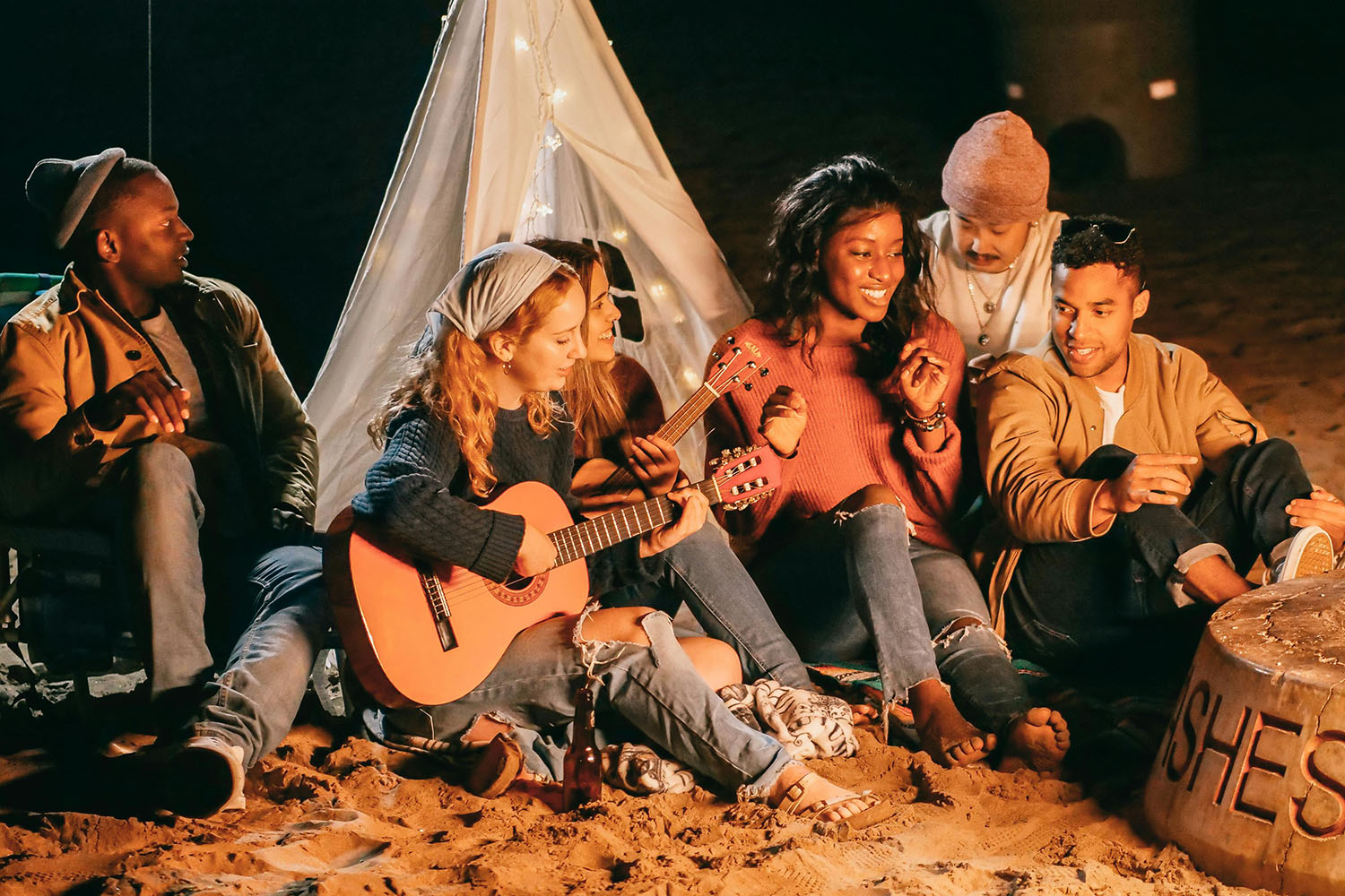 Group of friends sitting on the beach