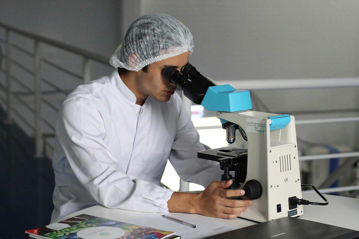 Scientist looking through a microscope