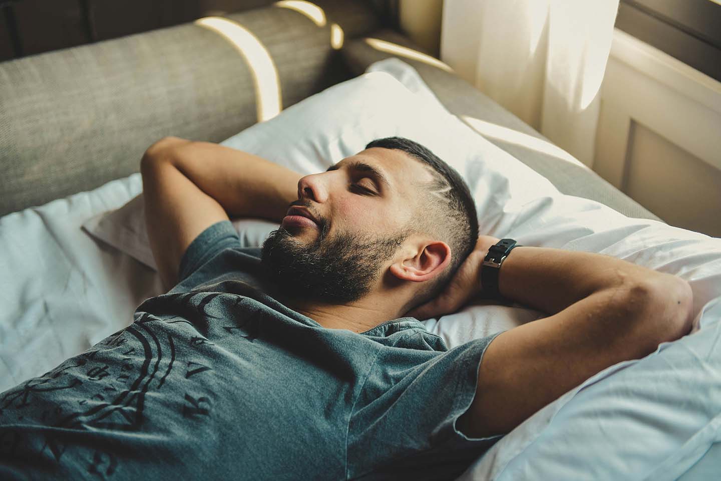 man looking happy while sleeping