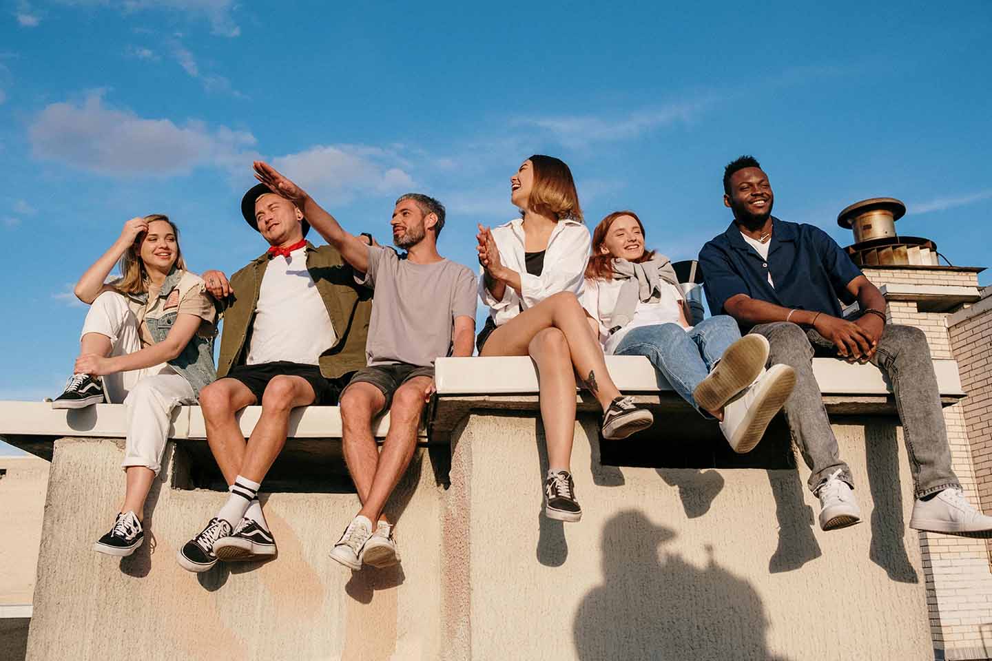 Group of friends sitting on a concrete bench