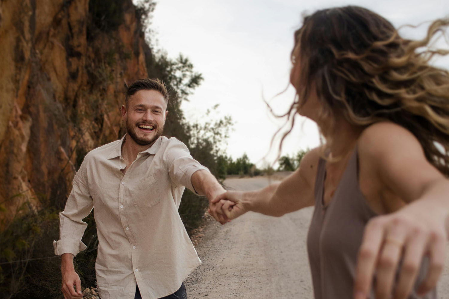 a couple holding hands and running happily