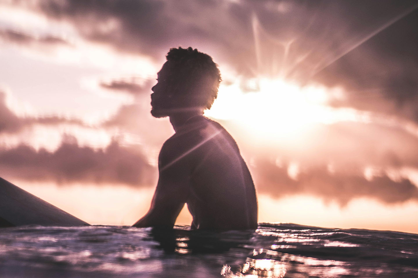 Man relaxing in the water at sundown