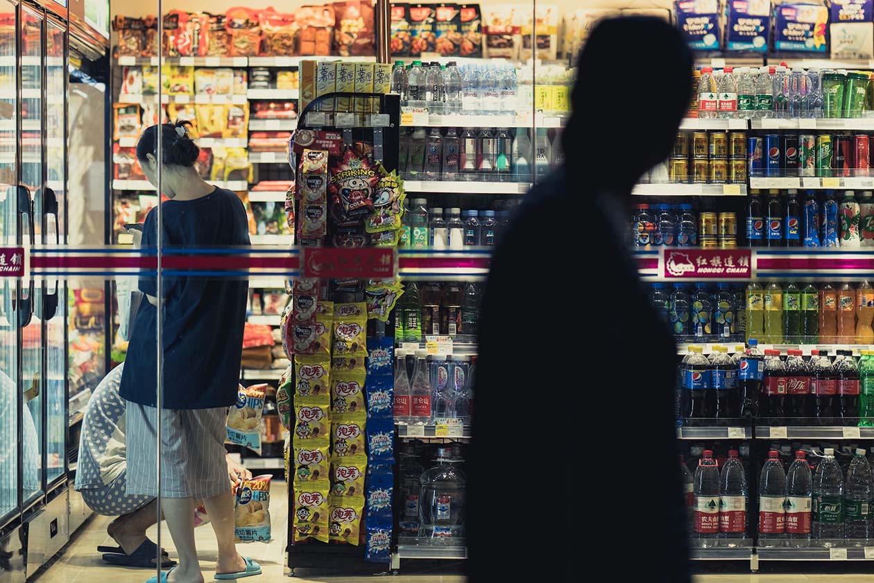 a convenience store with shoppers at night