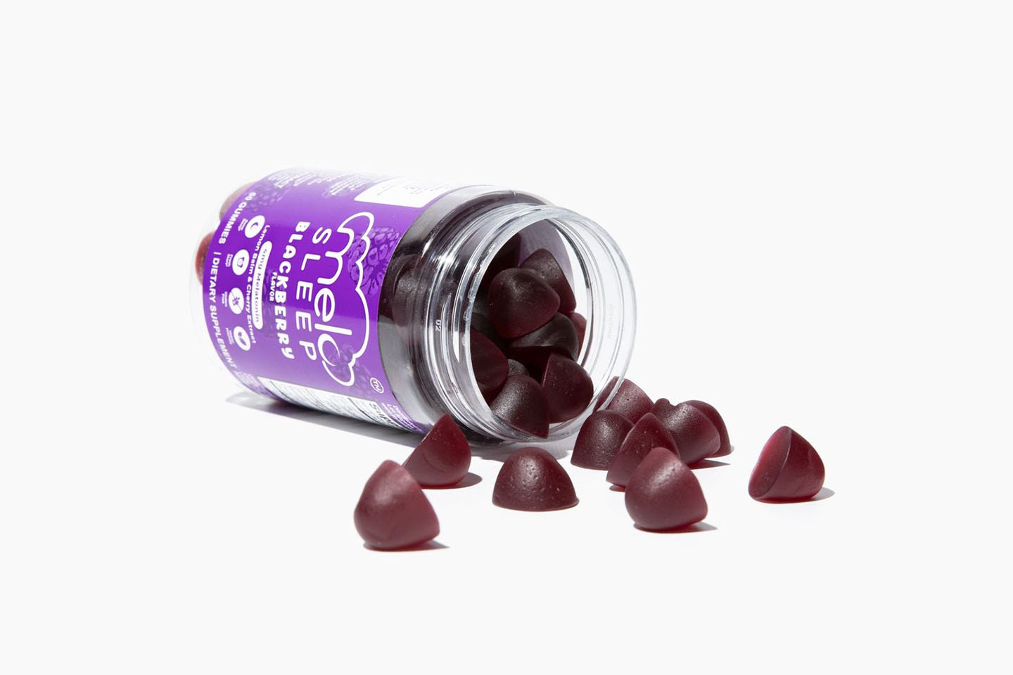 bottle of MELO Sleep Gummies on its side with gummies spilling out
