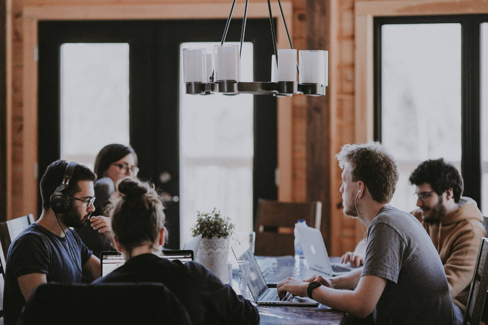 A group of people in the middle of meeting and discussing about work.