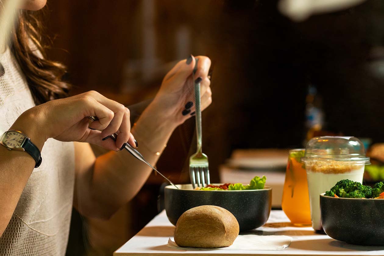 woman eating green salad