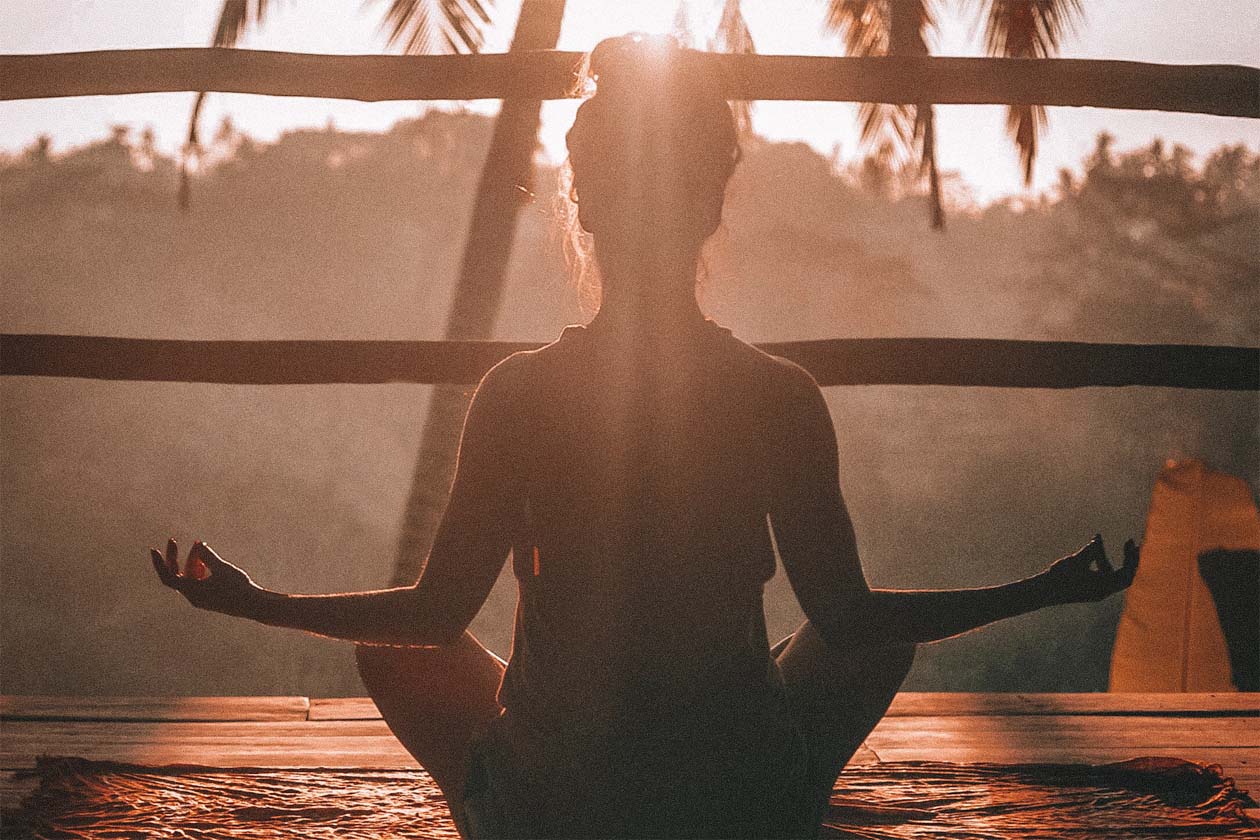 woman doing yoga at sunrise