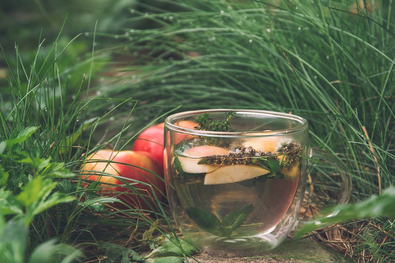 A cup of herbal tea on sand