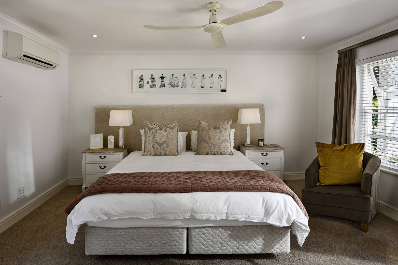 A bedroom with neatly arranged bedsheets and pillows.