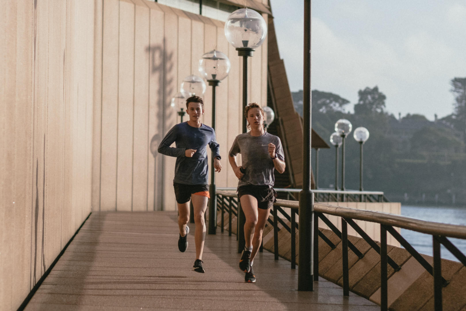 A man and a woman doing cardio runs early in the morning.