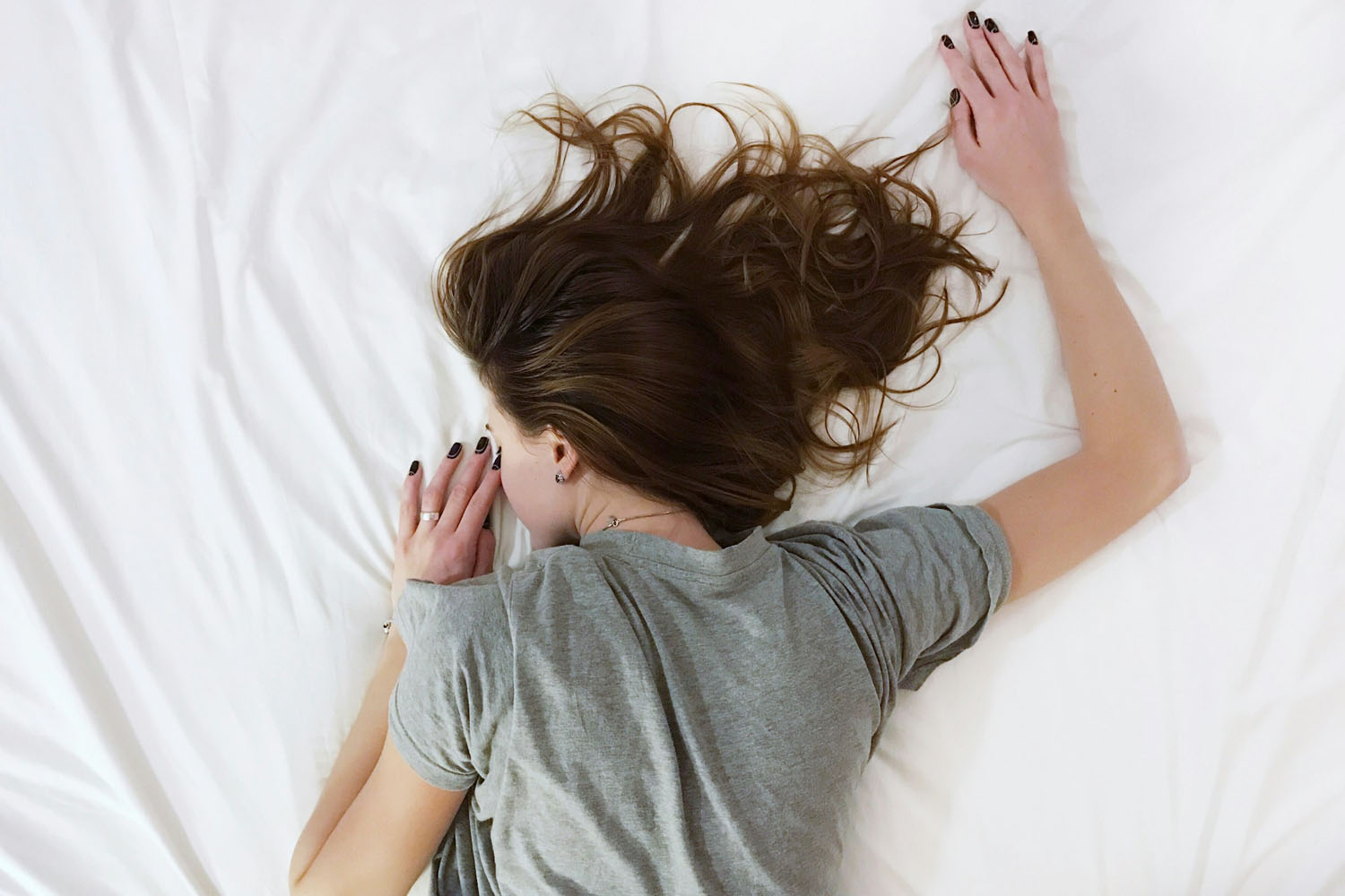 Woman laying face down on bed