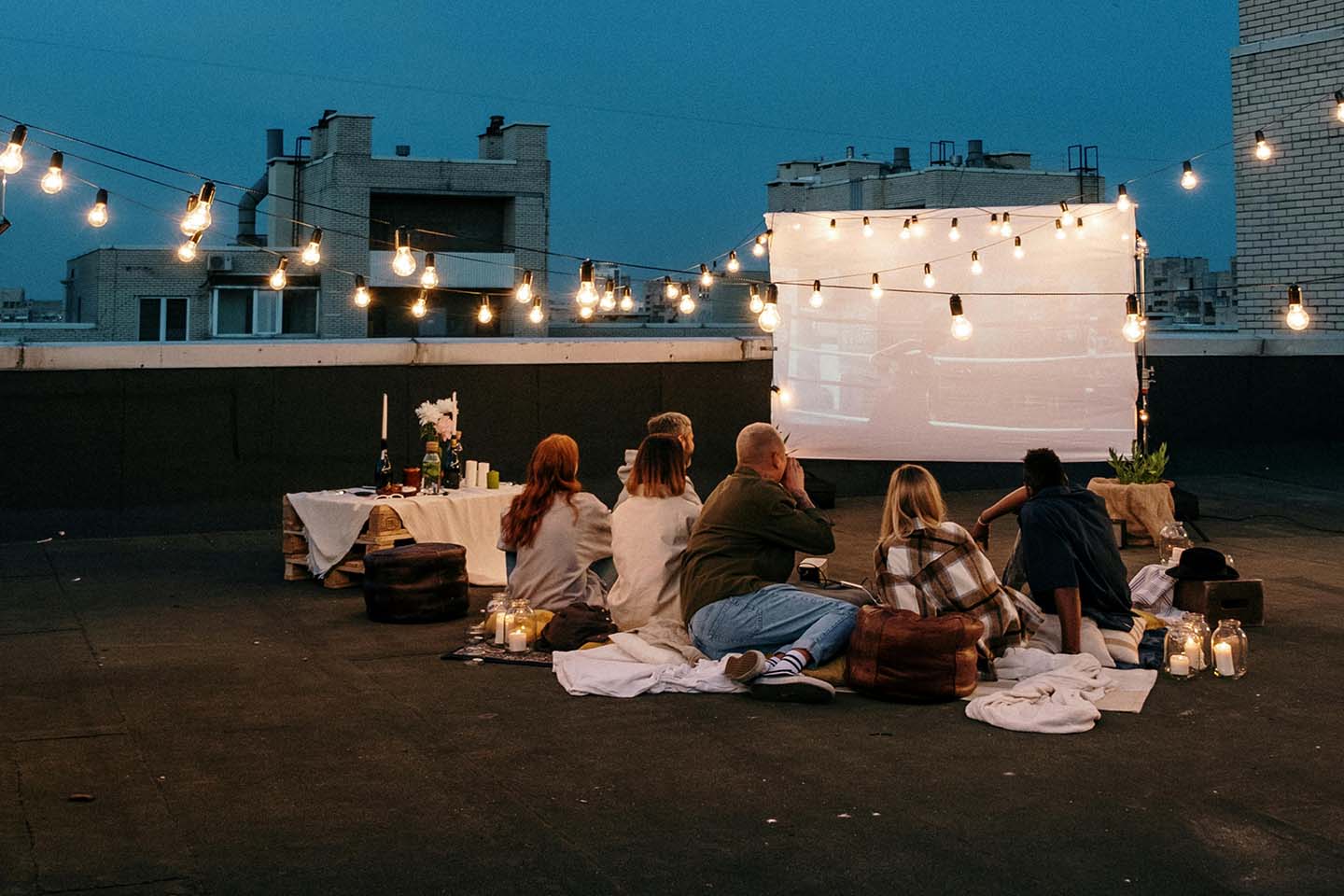 Group of people watching a movie outside