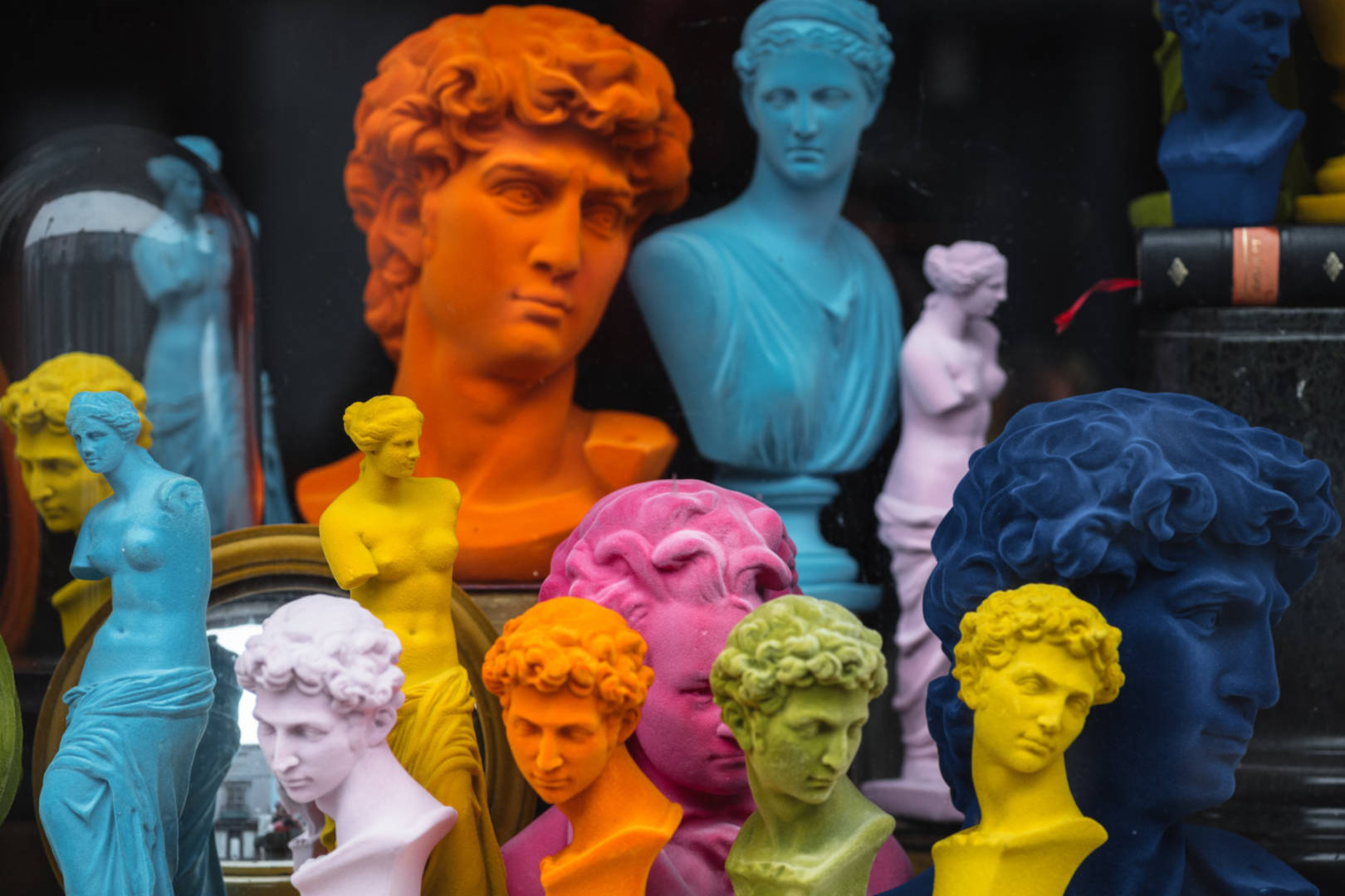 A selection of colorful bust sculptures displayed in a store.