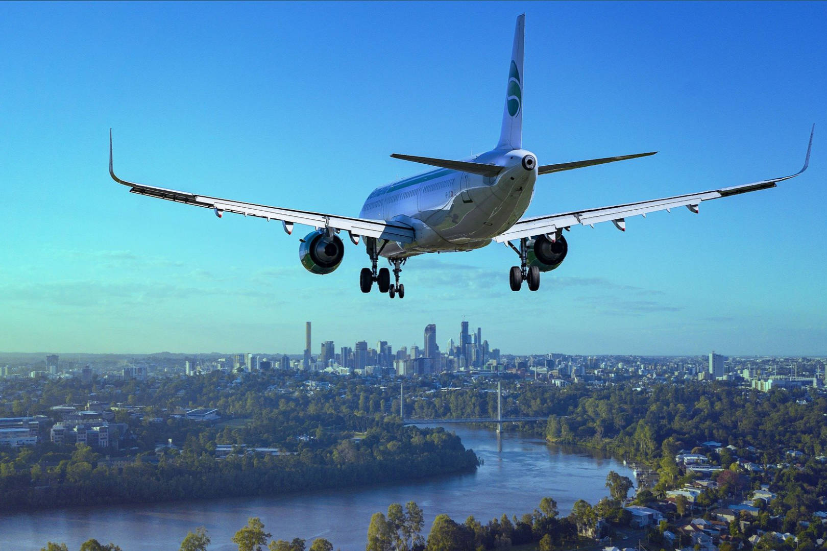 An airplane flying above an urban city.
