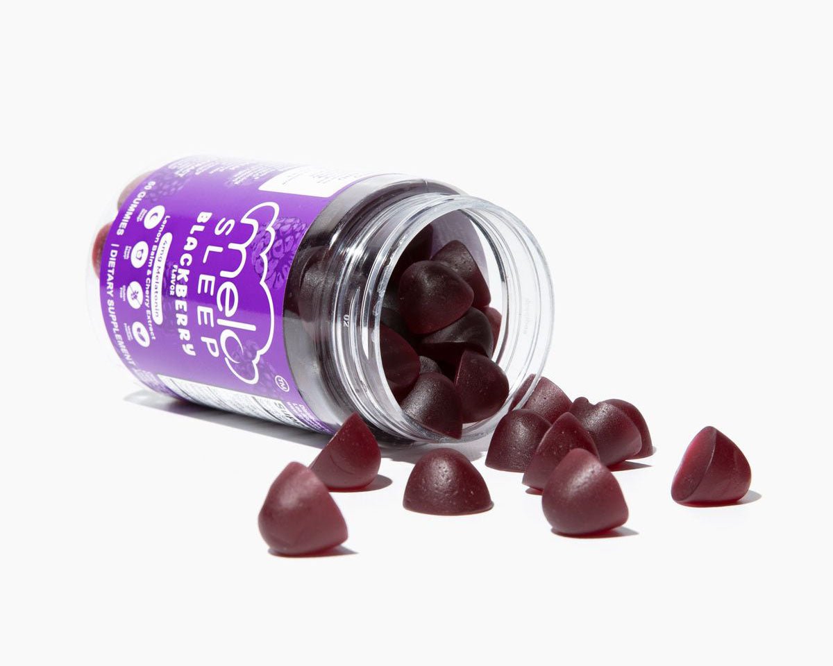 Blackberry-flavored MELO Sleep gummies spilling from an open bottle