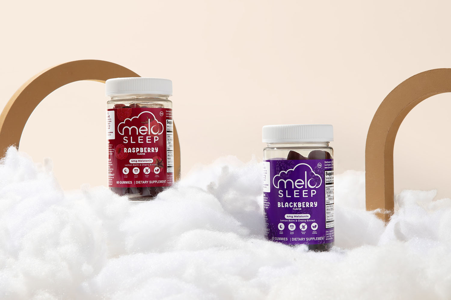 Two bottles of MELO Sleep gummies resting on fluffy clouds