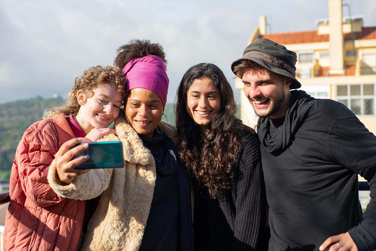 four friends smiling taking a selfie