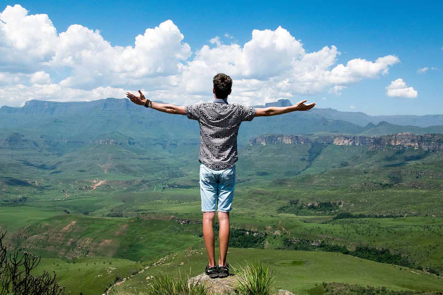 Man with outstretched arms on a mountaintop
