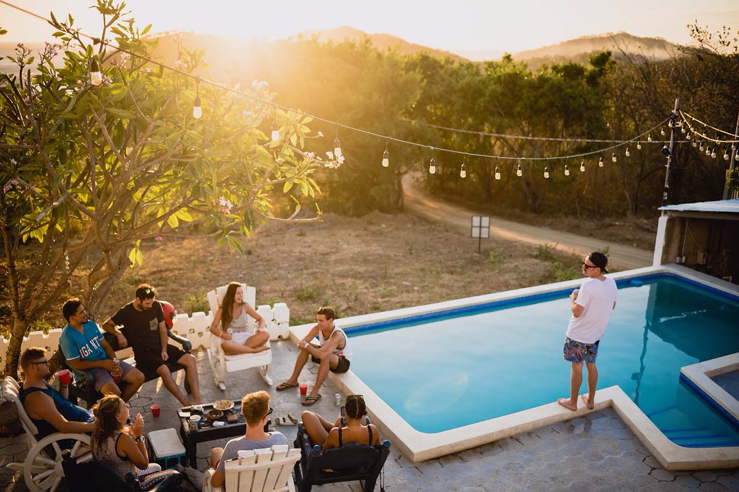 People sitting outside at swimming pool