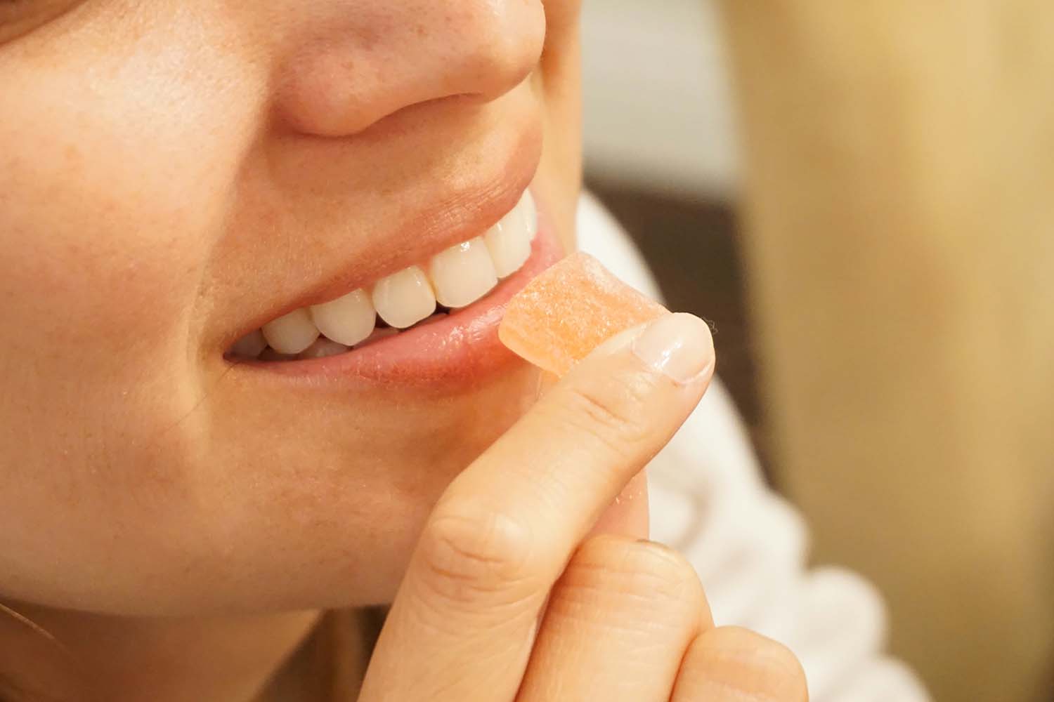 Woman holding orange gummy