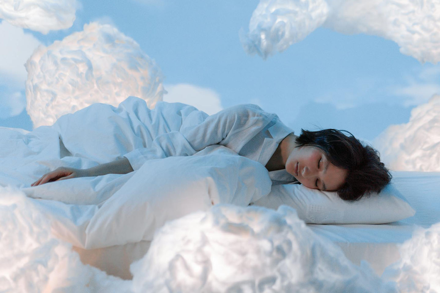 Woman sleeping among clouds